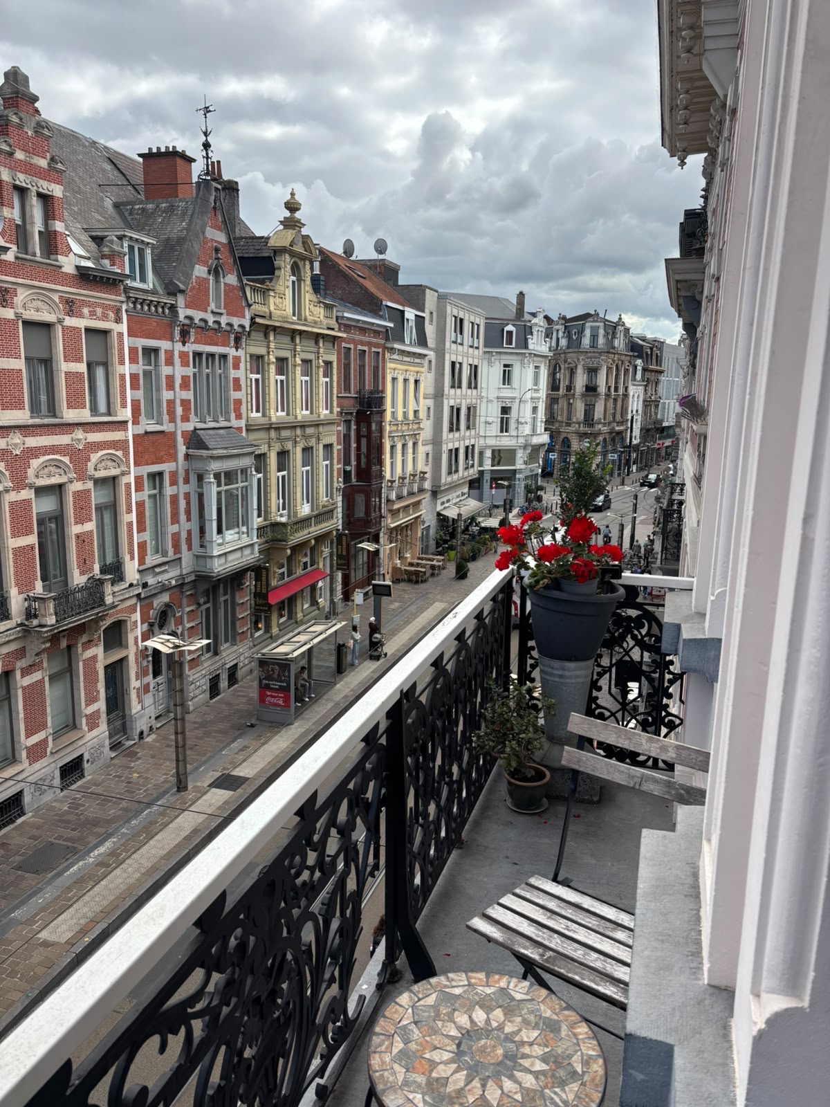 Room 1's balcony with flowers above the shopping street